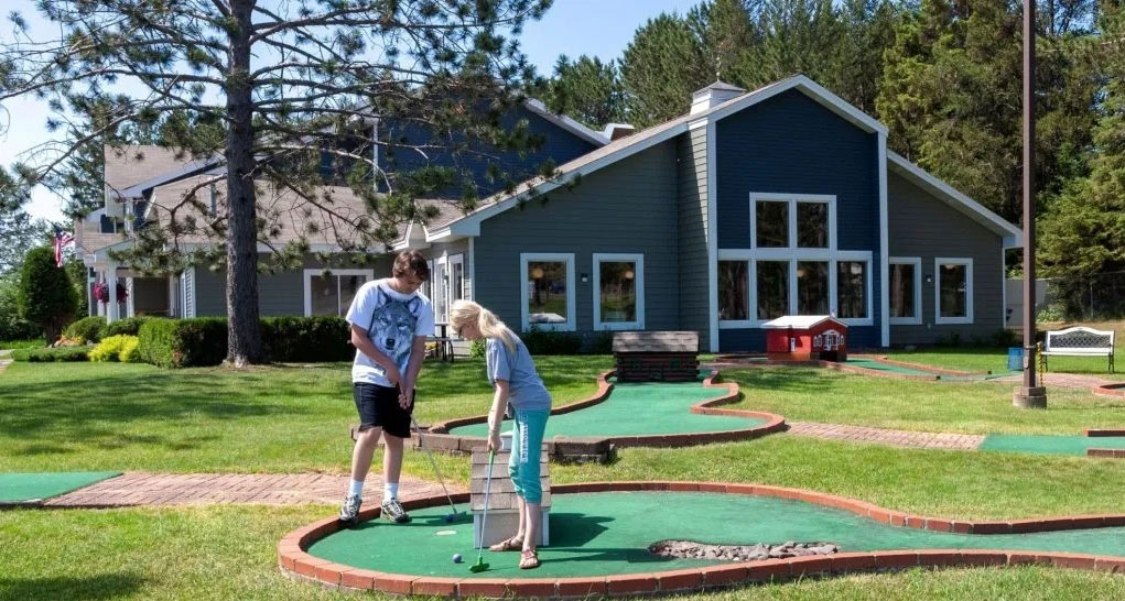 family playing mini golf at the Country Inn Two Harbors