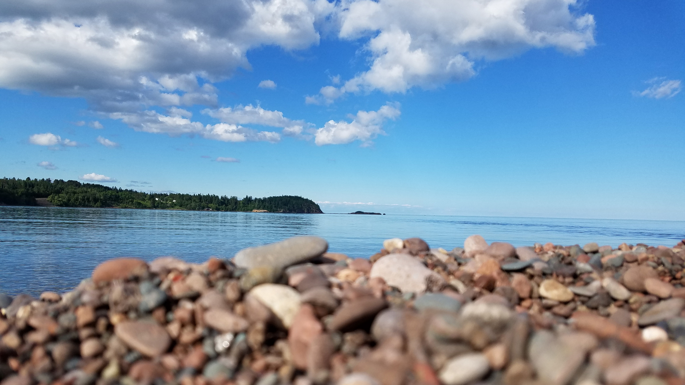 Close up of rocks on a Lake Superior beach on a partly cloudy day